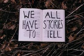 We All Have Stories To Tell written in open book on ground