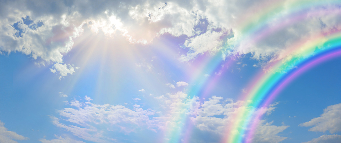 Beautiful vibrant double rainbow Cloudscape Background - awesome blue sky with pretty clouds, bright sun shining down and a large double rainbow arcing across the right corner