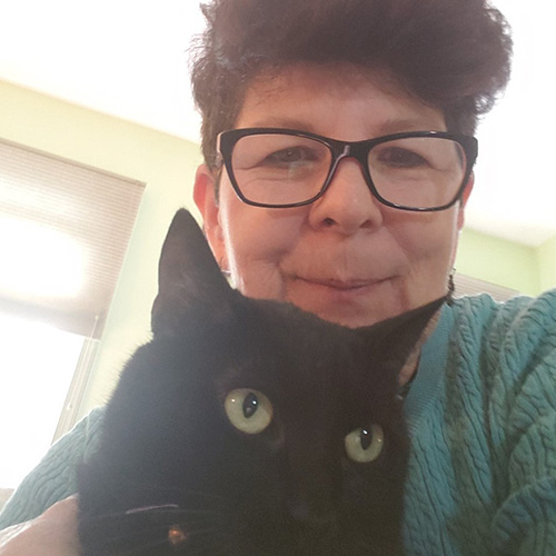 Maribeth Decker Medical intutitive for pets shown here with her black cat Shadow